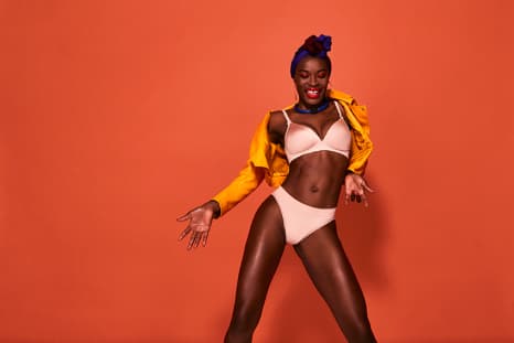 A black woman dancing comfortably in seam-free underwear from Bendon