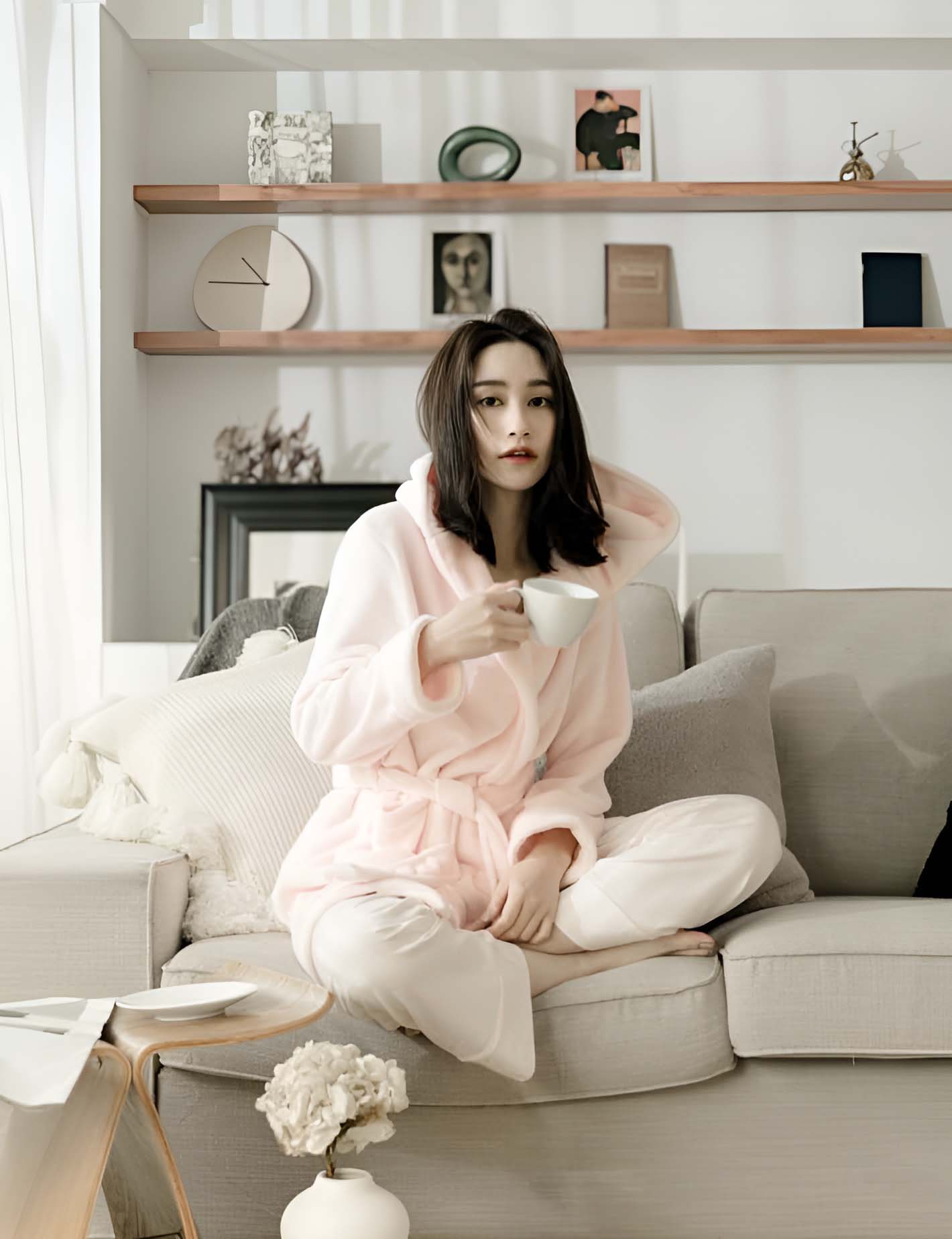 Asian woman modelling a sixty eight dressing gown in a living room setting.